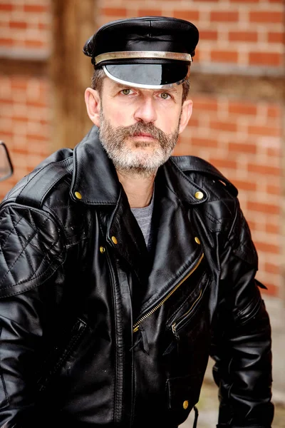 Handsome sexy bearded man dressed in black leather — Stock Photo, Image