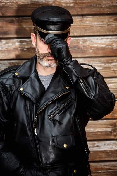 Handsome sexy bearded man dressed in black leather — Stock Photo, Image