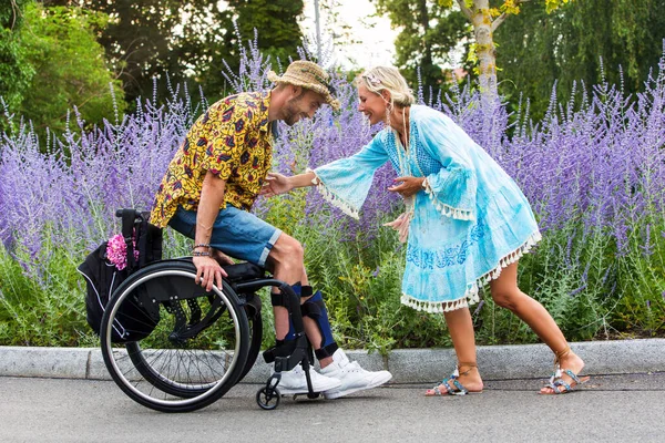 Blond Woman Blue Dress Outdoors Helping Man Wheelchair Get — Stock Photo, Image