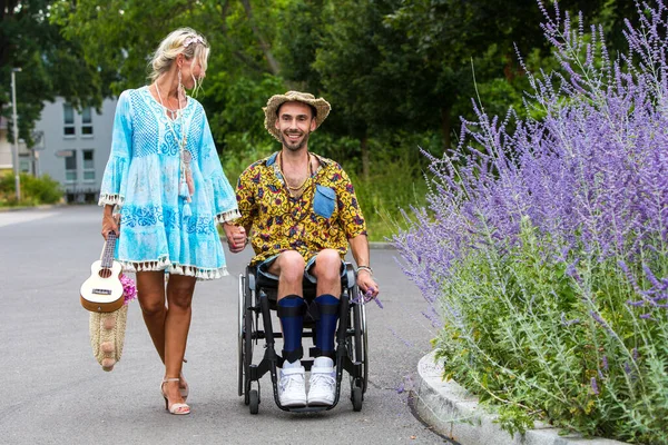 Blond Žena Modrých Šatech Chůze Mužem Invalidním Vozíku Podél Ulice — Stock fotografie