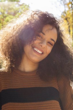 Young afro american woman looking at camera and smiling.