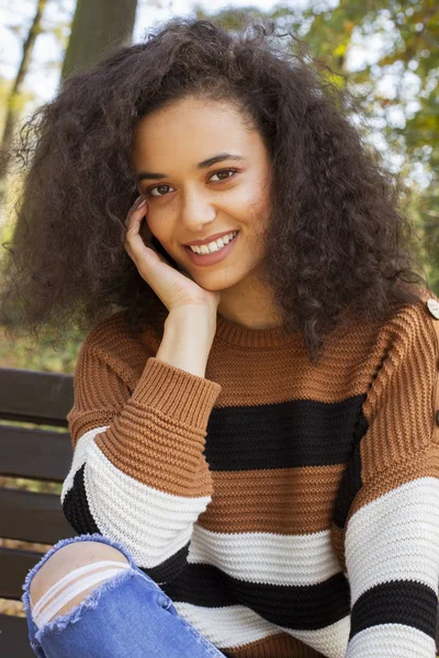 Young afro american woman looking at camera and smiling.
