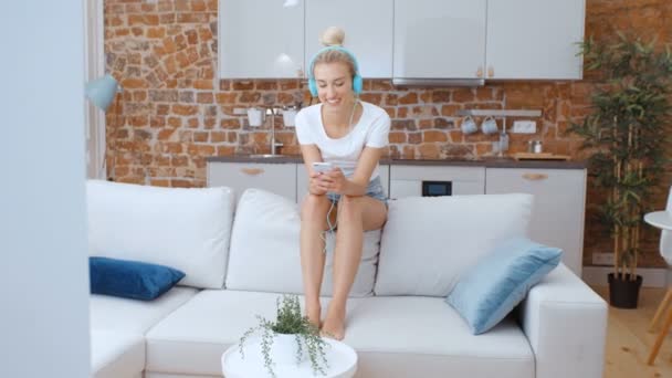 Young Woman Smartphone Headphones Home — Stock Video