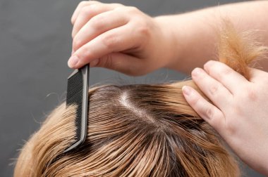 Saç rengi, radikal bir değişim. Sarışın kadın Efendi boya saçları koyar.