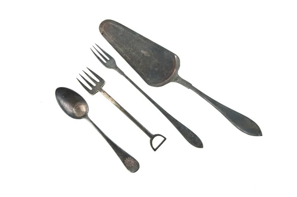 Forks, tea spoon and spatula in deep patina — Stock Photo, Image