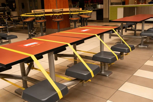 Social distancing rules in practice, alternate seating in public food courts in malls or shopping centres. Safety measures. Reopen cafe, food courts, restaurants after pandemic, new life after virus.