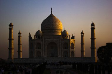 Agra, Hindistan - 10 Nisan 2014: Tajmahal 'e yakın, dramatik gün doğumunda kısmen aydınlanan yedi harikadan biri