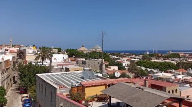 Rodos, Yunanistan - 23 Eylül 2020: Rodos şehrinde inşa edilen evler, ortaçağ tarzı Yunan mimarisi ve şatosu güneş paneli kullanılarak evlere karşı çekilmiştir