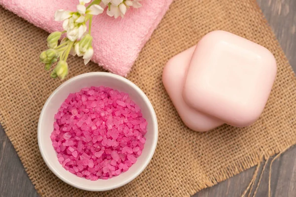 Pink spa accessories, soap towels and salt