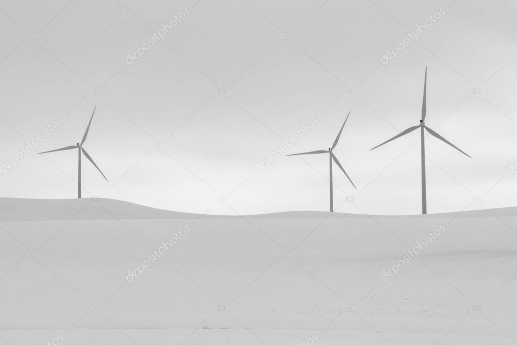 Windmills in Snow Covered Fields in Winter