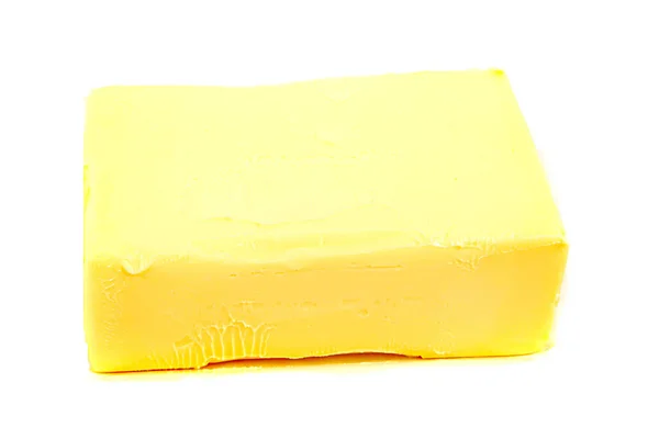Pedazo de mantequilla sobre un fondo blanco aislado —  Fotos de Stock