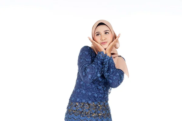 Closeup of a beautiful female Muslim model wearing dark blue modern kurung with hijab, a modern urban lifestyle apparel for Muslim women isolated on white background. Beauty and hijab fashion concept.