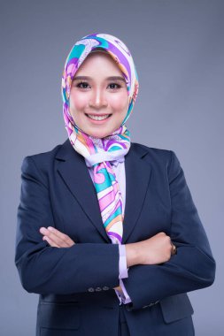 Çekici bir Müslüman kadının yarım boy portresi iş elbisesi ve karışık pozlar ve gri arka planda izole edilmiş jestler giymiş. Teknoloji, iş ya da finans için görüntü kesimi.