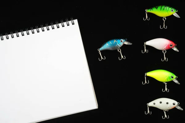 Creative arrangements of wobbler lures. Fishing lure with hooks. Plastic fish with hooks. Flat lay or top view.