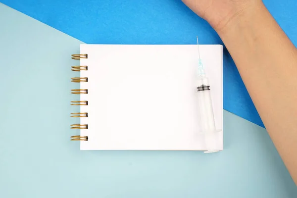 Medical or healthcare concept. Medical apparatus such as stethoscope and spiral notepad on blue background. Flat lay view.