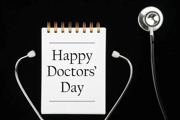 Thank you Doctors. Doctor\'s Day concept. Medical apparatus such as stethoscope and spiral notepad with \