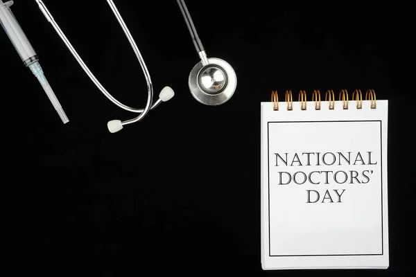 Thank you Doctors. Doctor\'s Day concept. Medical apparatus such as stethoscope and spiral notepad with \