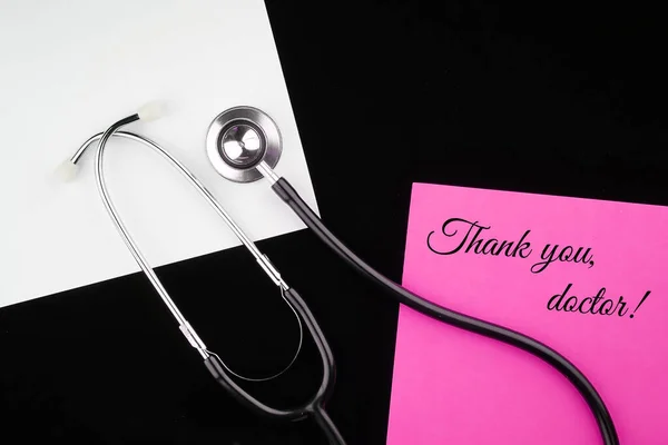 Thank you Doctors. Doctor\'s Day concept. Medical apparatus such as stethoscope and spiral notepad with \