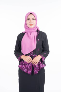 Kebaya ve tesettürde güzel bir kadın modeli, beyaz arka planda soyutlanmış Müslüman kadınlar için modern bir yaşam tarzı. Güzellik ve tesettür moda konsepti. Yarım boy portre