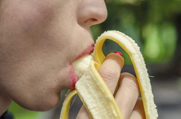 Woman with Red Lips Eating Banana. Blowjob Concept