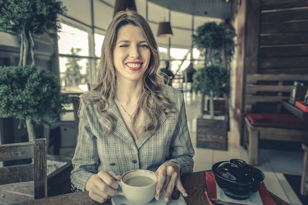beautiful woman drinking coffee in a cafe