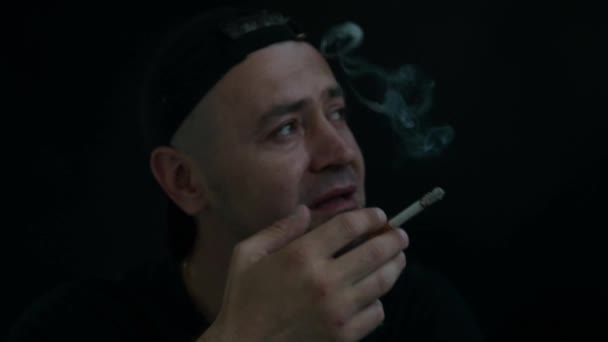 Closeup Portrait Upset Man Smokes Cigarette Black Background — Stock Video