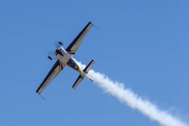 Avalon, Australia - March 2, 2013: British aerobatic pilot Mark Jefferies flying a single engine Extra 330LX aerobatic aircraft VH-IXN. clipart