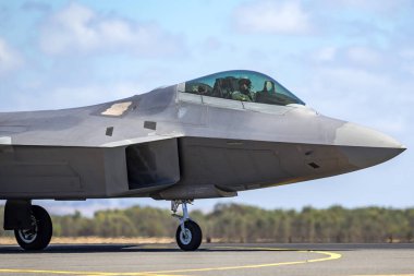 Avalon, Australia - March 2, 2013: United States Air Force (USAF) Lockheed Martin F-22A Raptor fifth-generation, single-seat, twin-engine, stealth tactical fighter aircraft. clipart
