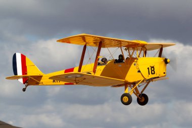Rowland Flat, Australia - April 14, 2013: De Havilland Australia DH-82A Tiger Moth single engine biplane aircraft formerly used for pilot training by the Royal Australian Air Force. clipart