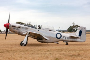 RAAF Williams, Point Cook, Australia - March 1, 2014: Former Royal Australian Air Force (RAAF) Commonwealth Aircraft Corporation CA-18 Mustang VH-AGJ (North American P-51D Mustang) world war II fighter plane. clipart