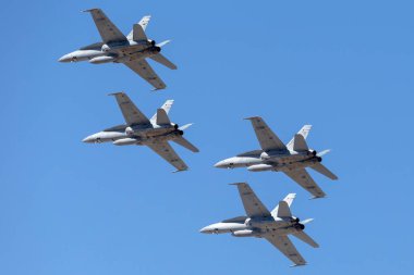 RAAF Williams, Point Cook, Australia - March 2, 2014: Formation of four Royal Australian Air Force (RAAF) McDonnell Douglas F/A-18A Hornet multirole fighter aircraft. clipart