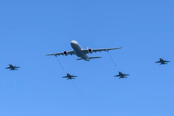 RAAF Williams, Point Cook, Australia - March 2, 2014: Royal Australian Air Force (RAAF) Airbus KC-30A Multi Role Tanker Transport Aircraft A39-003 filling four McDonnell Douglas F / A-18 Hornet fighter aircraft
.