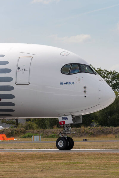 Farnborough, UK - July 18, 2014:  Airbus A350-941 commercial aircraft with a hybrid Airbus/Qatar Airways livery.