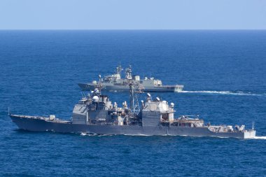 Sydney, Avustralya - 11 Ekim 2013: USS Chosin (CG-65) Ticonderoga sınıfı güdümlü füze kruvazörü ve Avustralya Kraliyet Donanması Anzak sınıfı firkateyni HMAS Parramatta denizde yelken açıyor. 