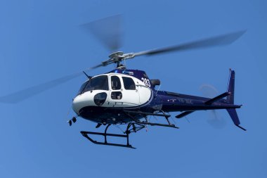 Sydney, Australia - October 11, 2013: Eurocopter AS 350B3 Helicopter VH-XGC conducting aerial filming over Sydney Harbour. clipart