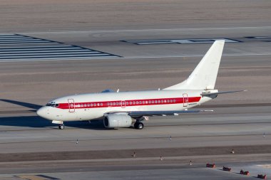 Las Vegas, Nevada, USA - May 7, 2013: Boeing 737 operated by defense contractor EG&G (Janet Airlines) to transport workers to and from the highly secretive and famous Area 51 base at Groom Lake. clipart
