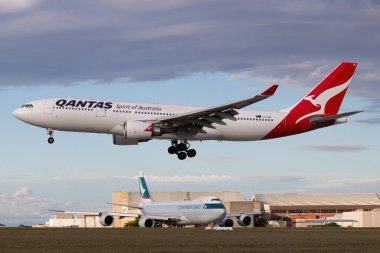 Melbourne, Australia - June 23, 2015: Airbus A330 large twin engine airliner operated by Qantas on approach to land at Melbourne International Airport. clipart