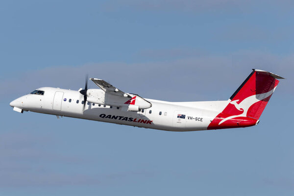 QantasLink (Eastern Australia Airlines) de Havilland Canada Dash 8 twin engine turboprop regional airliner aircraft taking off from Sydney Airport.