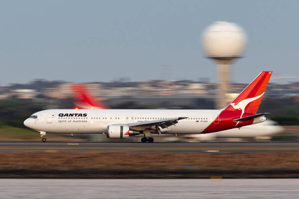 Sydney, Australia - October 9, 2013: Qantas Boeing 767 airliner landing at Sydney Airport.