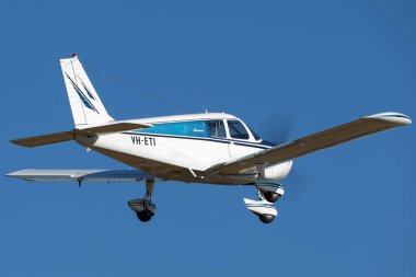 Tyabb, Avustralya - 9 Mart 2014: Piper Cherokee (PA-28-140) tek gözlü hafif uçak VH-ETI mavi gökyüzüne doğru uçuyor.