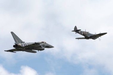RAF Waddington, the UK - 6 Temmuz 2014: Royal Air Force (RAF) Eurofighter EF-2000 Typhoon from No.29 (R) Squadron with a Supermarine Spitfire from the Battle of Britain Memorial Flight Flight.