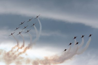 Payerne, Switzerland - September 1, 2014: Patrouille Suisse formation display team of the Swiss Air Force flying Northrop F-5E fighter aircraft joined by the Swiss PC-7 team flying Pilatus PC-7 trainer aircraft.