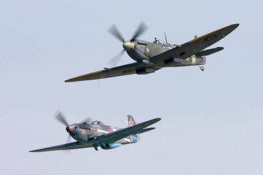 Payerne, Switzerland - September 5, 2014: Supermarine Spitfire Mk16e World War II fighter aircraft G-MXVI flying in formation with Yakovlev Yak-3M.