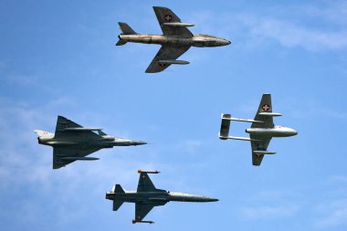 Payerne, Switzerland - September 7, 2014: Formation of former Swiss Air force jet aircraft comprised of a de Havilland Vampire, Hawker Hunter, Northrop F-5 and Dassault Mirage. 