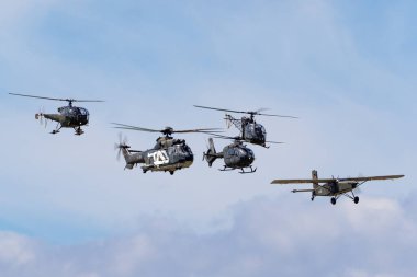 Payerne, Switzerland - August 29, 2014: Formation of aircraft from the Swiss Air Force comprised of an Aerospatiale Alouette, Aerospatiale Alouette II, Eurocopter EC-635, Aerospatiale AS332 and a Pilatus Porter.