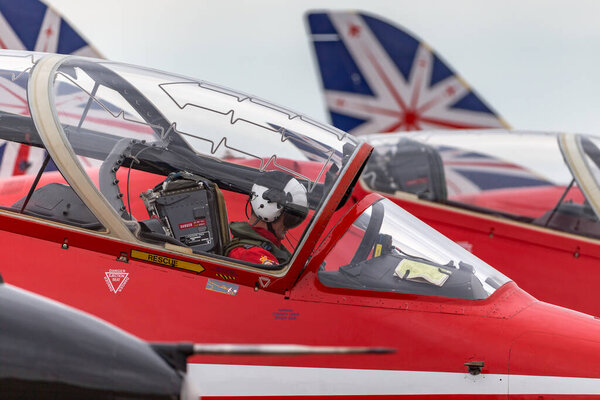 RAF Fairford, Gloucestershire, UK - July 12, 2014: Royal Air Force Pilot in the cockpit of a Red Arrows British Aerospace Hawk T.1 jet trainer aircraft. 