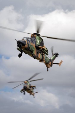 Avalon, Australia - February 26, 2015: Two Australian Army Eurocopter Tiger ARH Armed reconnaissance helicopters. clipart
