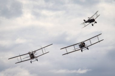 Avalon, Australia - February 27, 2015: Bristol F.2 Fighter (replica) British two-seat biplane fighter and reconnaissance aircraft of the First World War flying in formation with a Royal aircraft factory R.E.8. clipart