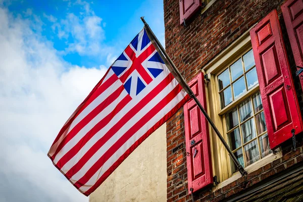 The Grand Union Flag, also called the Continental Colors, Congress Flag, Cambridge Flag, or First Navy Ensign is generally considered the first flag of the USA.
