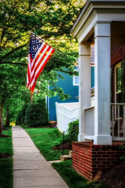 American flag hanging on the front door at sunrise near Fort Belvoir, Virginia.